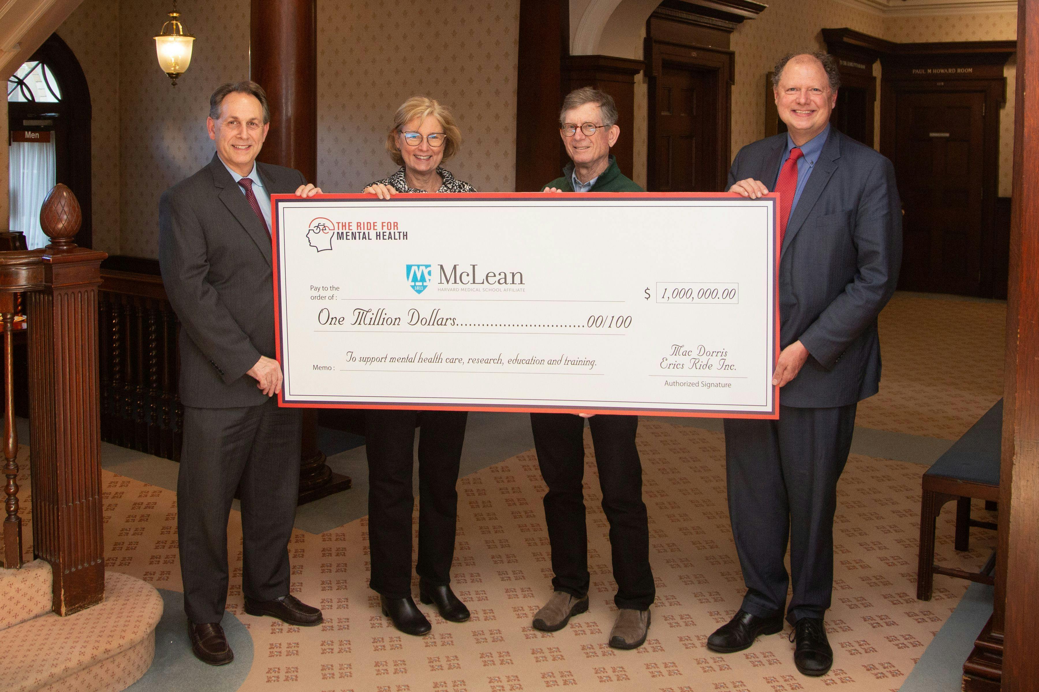 The Ride for Mental Health founder Mac Dorris and his wife, Ginny Dorris, with representatives of McLean Hospital holding a check recognizing $1 million in total contributions to McLean since 2017. Photo courtesy of the Ride for Mental Health.